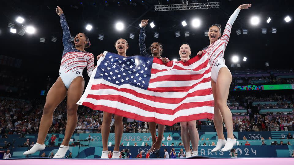 (Left to right) Team USA's Jordan Chiles, Hezly Rivera, Simone Biles, Jade Carey, and Sunisa Lee celebrate winning the Paris Olympics' artistic gymnastics women's team final. - Naomi Baker/Getty Images