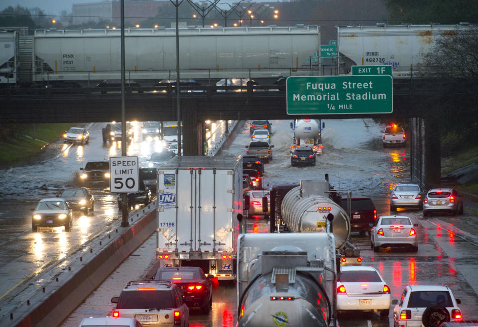 Cars stack up northbound on Interstate 110, as they encounter high water in the roadway under the railroad bridge near the governor's mansion, as even fewer vehicles opt to try to navigate the water as they progress southbound after heavy rains, Thursday, Dec. 27, 2018, in Baton Rouge, La. (Travis Spradling/The Advocate via AP)