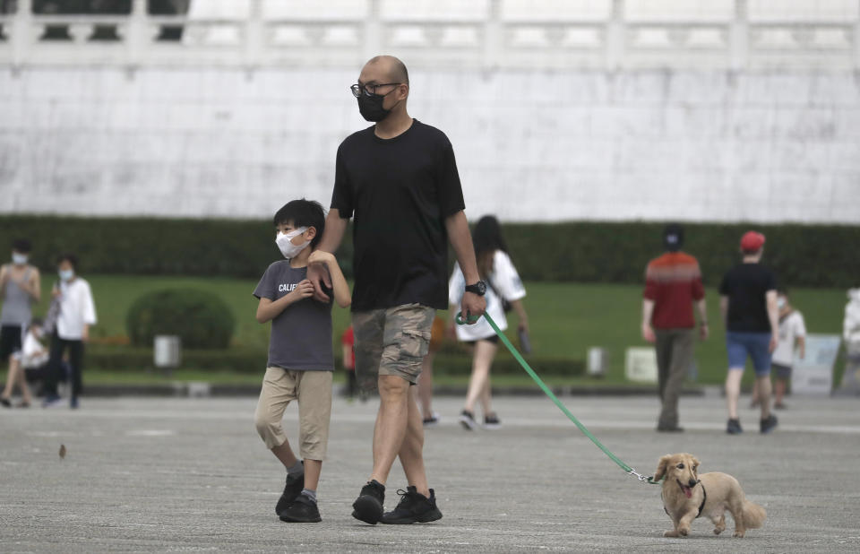 People wear face masks to protect against the spread of the coronavirus in Taipei, Taiwan, Wednesday, April 27, 2022. (AP Photo/Chiang Ying-ying)