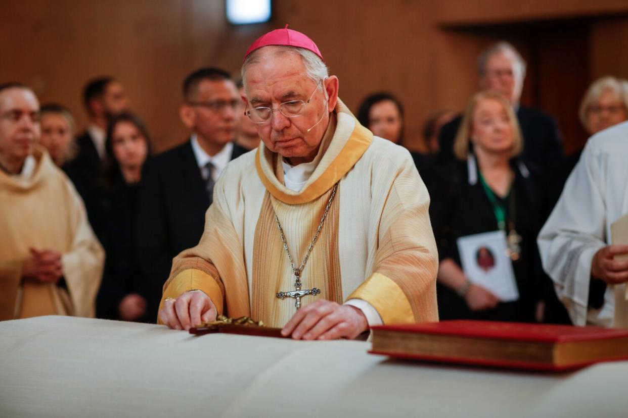 Archbishop Jose H. Gomez places Christian symbols; The Book of Gospels and a Cross,