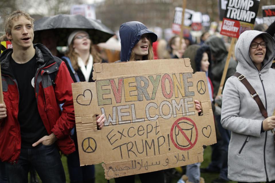 A demonstrator holds a placard as she takes part in a protest outside the U.S. embassy in London, against U.S. President Donald Trump's ban on travellers and immigrants from seven predominantly Muslim countries entering the U.S., Saturday, Feb. 4, 2017. (AP Photo/Matt Dunham)