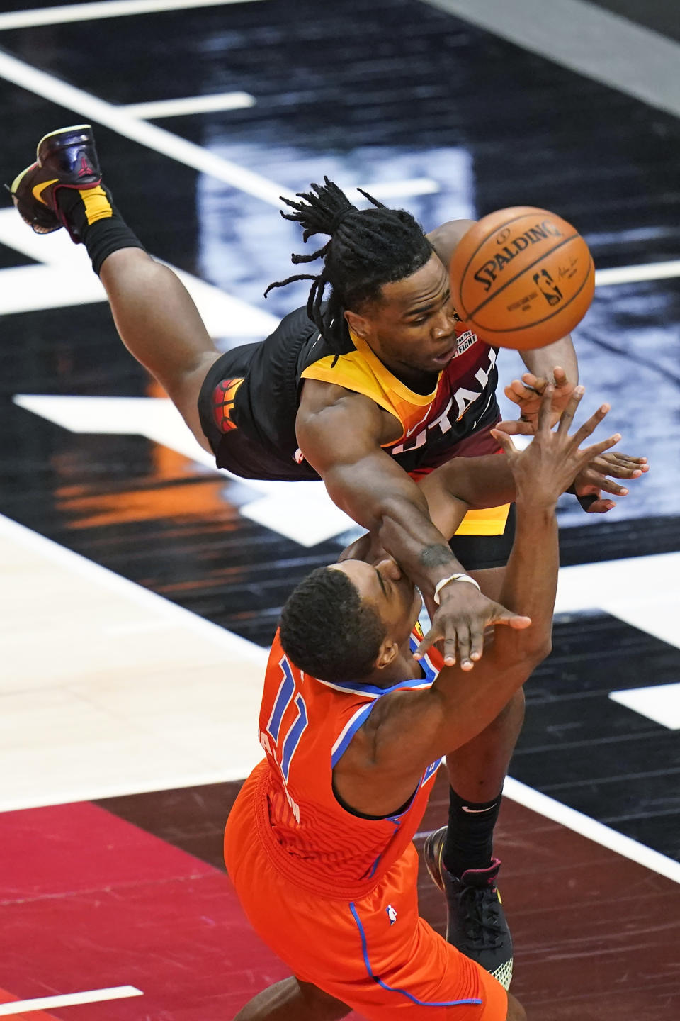 Utah Jazz forward Jarrell Brantley, top, fouls Oklahoma City Thunder guard Theo Maledon (11) during the second half of an NBA basketball game Tuesday, April 13, 2021, in Salt Lake City. (AP Photo/Rick Bowmer)