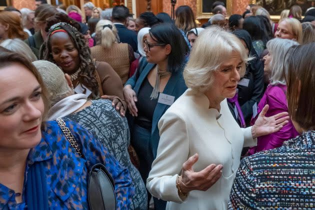 Queen Consort Camilla speaks to guests near Ngozi Fulani (back left), chief executive of the London-based Sistah Space group, during a reception to raise awareness of violence against women and girls at Buckingham Palace on Nov. 29, 2022.
