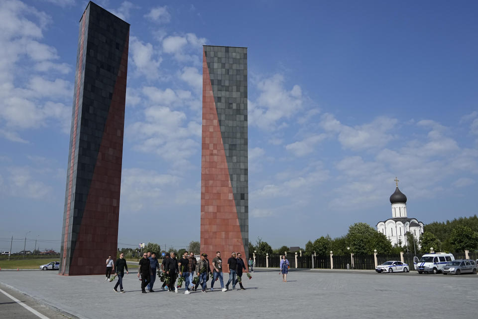 People walk to attend a farewell ceremony for Dmitry Utkin, who oversaw Wagner Group's military operations, at Federal Military Memorial Cemetery in Mytishchy, outside Moscow, Russia, Thursday, Aug. 31, 2023. Utkin, whose military call sign Wagner gave the name to the group, is presumed to have died in a plane crash along with Wagner's owner Yevgeny Prigozhin and other military company's officers. (AP Photo/Alexander Zemlianichenko)