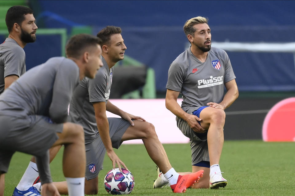 Atletico Madrid's Hector Herrera, right, takes part with his teammates during a training session at the Jose Alvalade stadium in Lisbon, Wednesday Aug. 12, 2020. Atletico Madrid will play Leipzig in a Champions League quarterfinals soccer match on Thursday. (Lluis Gene/Pool via AP)
