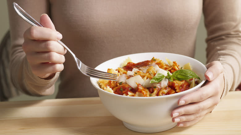 person eating pasta with fork