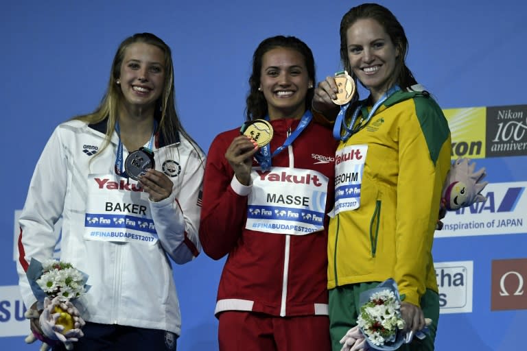 L-R: American Kathleen Baker, Canada's Kylie Jacqueline Masse and Australia's Emily Seebohm celebrate after the women's 100m backstroke final on July 25, 2017