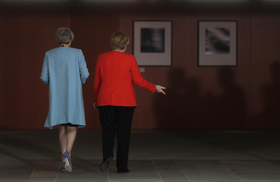 FILE - German Chancellor Angela Merkel, right, and British Prime Minister Theresa May leave after statements prior to a meeting in the chancellery in Berlin, Germany, on July 5, 2018. Merkel has been credited with raising Germany’s profile and influence, helping hold a fractious European Union together, managing a string of crises and being a role model for women in a near-record tenure. Her designated successor, Olaf Scholz, is expected to take office Wednesday, Dec. 8, 2021. (AP Photo/Markus Schreiber, File)