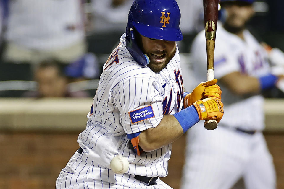 New York Mets' DJ Stewart reacts after being hit by a pitch with the bases loaded against the Texas Rangers during the 10th inning of a baseball game Wednesday, Aug. 30, 2023, in New York. The Mets won 6-5. (AP Photo/Adam Hunger)