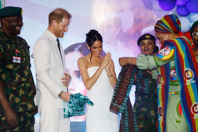 <p>Andrew Esiebo/Getty</p> Meghan Markle and Prince Harry receive gifts during a reception in Abuja on May 11, 2024