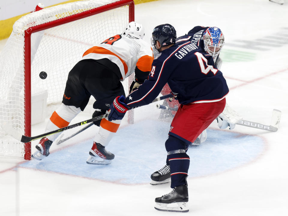 Philadelphia Flyers defenseman Ivan Provorov, left, scores past Columbus Blue Jackets goalie Joonas Korpisalo and defenseman Vladislav Gavrikov during the third period an NHL hockey game in Columbus, Ohio, Thursday, Nov. 10, 2022. The Blue Jackets won 5-2. (AP Photo/Paul Vernon)