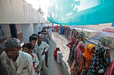 People wait in queues to cast their vote at a polling station at Sirohi district in Rajasthan, India April 29, 2019. REUTERS/Amit Dave