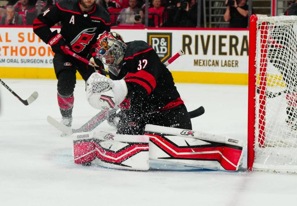 Jan 25, 2024; Raleigh, North Carolina, USA; Carolina Hurricanes goaltender Antti Raanta (32) stops the shot against the New Jersey Devils during the second period at PNC Arena. Mandatory Credit: James Guillory-USA TODAY Sports