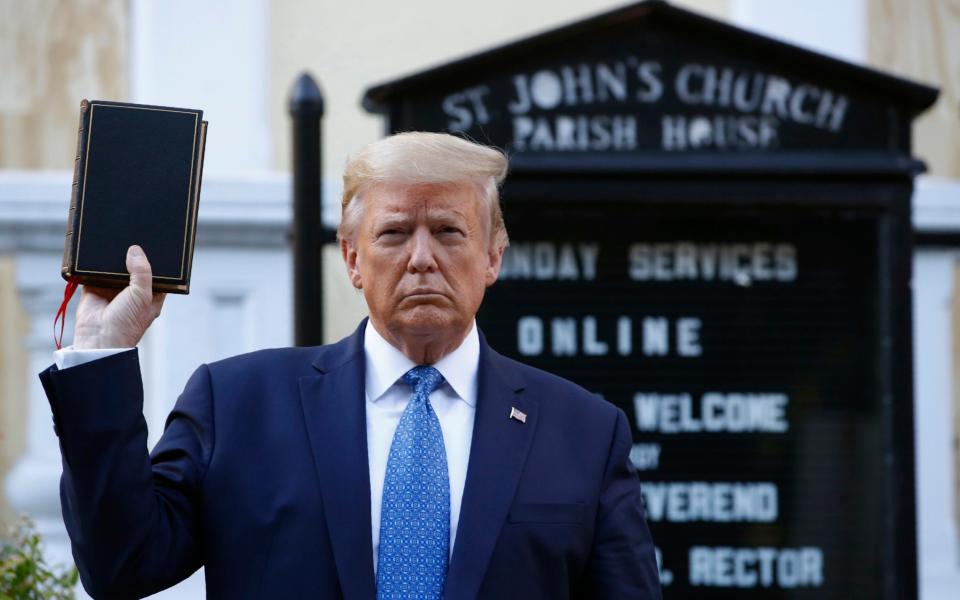 President Donald Trump holds a Bible as he visits outside St. John's Church across Lafayette Park from the White House on Monday - AP Photo/Patrick Semansky