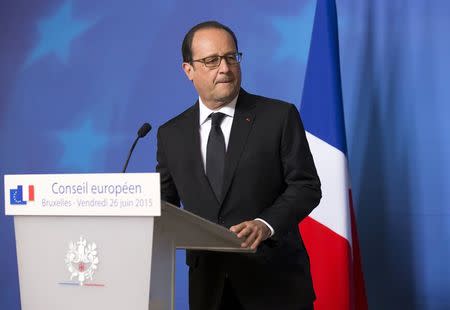 French President Francois Hollande gives a statement at the European Council headquarters in Brussels, June 26, 2015, following an attack at a U.S. gas company in Saint-Quentin-Fallavier, southeast France, where two assailants rammed a car into the premises, and a decapitated head was found. REUTERS/Philippe Wojazer