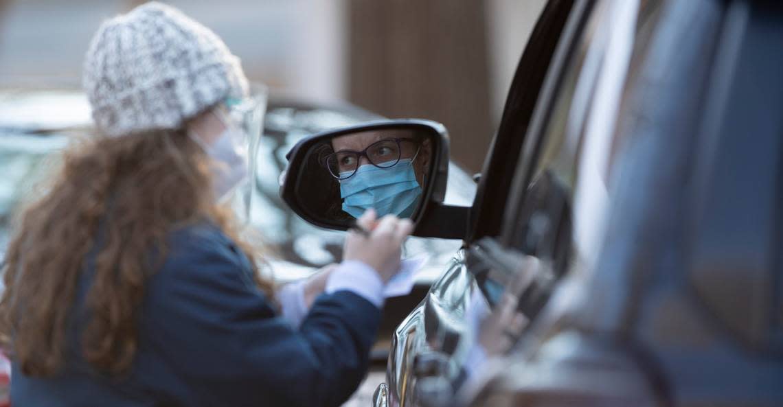 Wake County staff register participants for COVID-19 tests at a drive-thru testing site at Roberts Park on Tuesday, January 5, 2021 in Raleigh, N.C