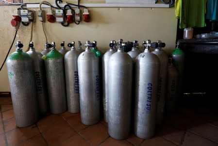 Diving oxygen tanks are seen in a room at Pearl Divers, a diving school, at Unawatuna beach in Galle
