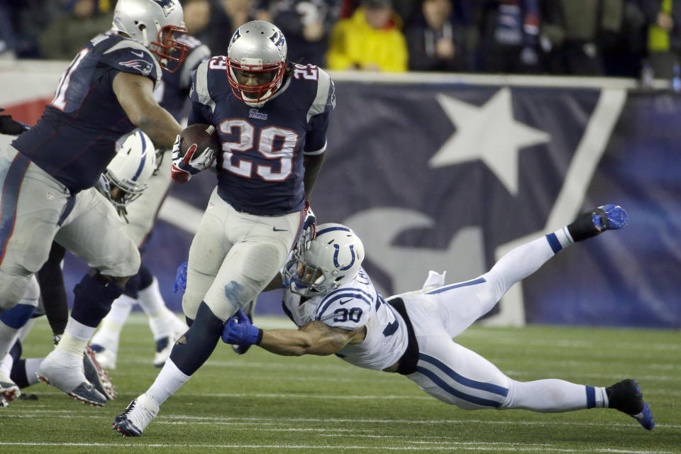 New England Patriots running back LeGarrette Blount (29) breaks free from Indianapolis Colts safety LaRon Landry (30) and heads downfield for a touchdown during the second half of an AFC divisional NFL playoff football game in Foxborough, Mass., Saturday, Jan. 11, 2014. (AP Photo/Matt Slocum)