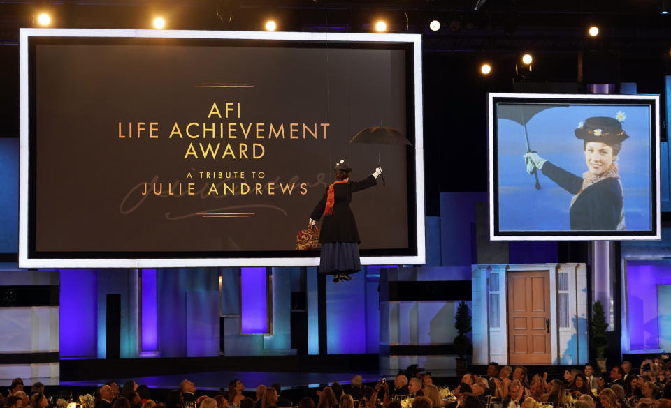A performer dressed as the movie character Mary Poppins is suspended above the audience at the 48th AFI Life Achievement Award Gala honoring Julie Andrews, Thursday, June 9, 2022, at the Dolby Theatre in Los Angeles. Andrews starred in the 1964 film "Mary Poppins." (AP Photo/Chris Pizzello)