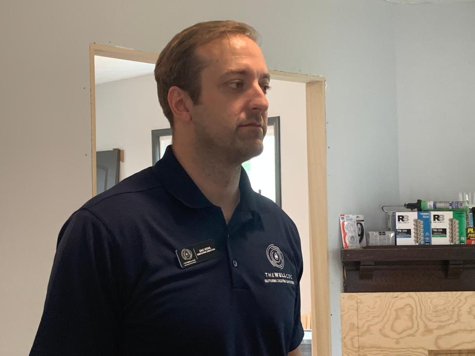 The Well CDC Executive Director Zac Kohl talks to Knight Foundation Program Director Kyle Kutuchief after the Thursday morning press conference. The Knight Foundation gave the Well CDC a $4 million grant to rebuild homes.