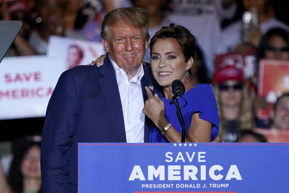 FILE - Arizona Republican Gubernatorial candidate Kari Lake speaks as former President Donald Trump listens during a rally, Oct. 9, 2022, in Mesa, Ariz Lake lost the race for Arizona governor but she built a loyal following that stretches far beyond the state. Her meteoric rise is virtually unheard of for a first-time candidate who started her campaign with no national profile. It's earned her a prominent spot in the speculation about a running mate for Trump, and she's seriously considering a run for U.S. Senate. (AP Photo/Matt York, File)