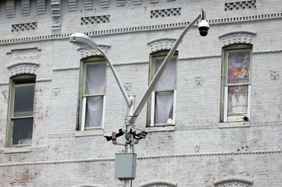 Video cameras and license plate readers, like those attached to this Baltimore streetlight, monitor and record the comings and goings of pedestrians and cars on city streets. <a href="https://newsroom.ap.org/detail/BaltimoreAerialSurveillance/2bd5050cf1874c85911db98629799f45/photo" rel="nofollow noopener" target="_blank" data-ylk="slk:AP Photo/Julio Cortez;elm:context_link;itc:0;sec:content-canvas" class="link ">AP Photo/Julio Cortez</a>