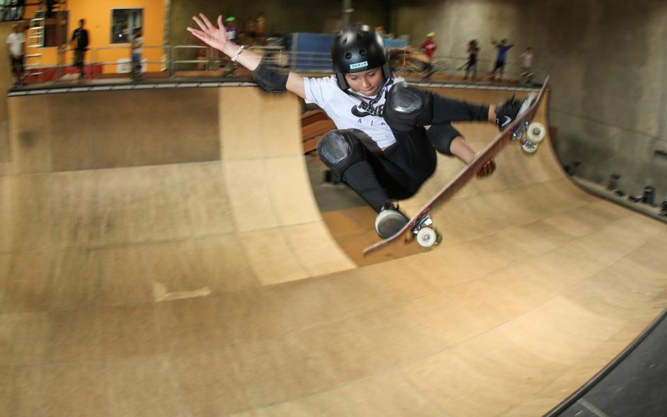 Professional skateboarder and British Olympic athlete Sky Brown gets some air while riding Tony Hawk's office ramp - REUTERS