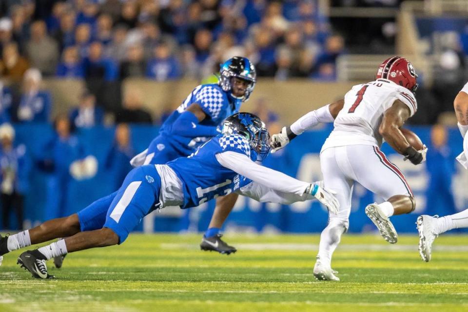 Kentucky linebacker J.J. Weaver (13) reaches to tackle South Carolina running back MarShawn Lloyd (1) during a game at Kroger Field on Oct. 8, 2022.