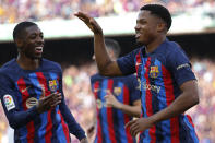 Barcelona's Ansu Fati, right, celebrates with Ousmane Dembele after scoring the opening goal during a Spanish La Liga soccer match between Barcelona and Mallorca at the Camp Nou stadium in Barcelona, Spain, Sunday, May 28, 2023. (AP Photo/Joan Monfort)