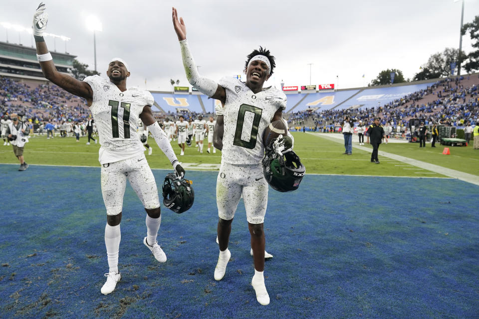 Oregon cornerback DJ James (0) and cornerback Trikweze Bridges (11) celebrate after a win over UCLA in an NCAA college football game Saturday, Oct. 23, 2021, in Pasadena, Calif. (AP Photo/Marcio Jose Sanchez)