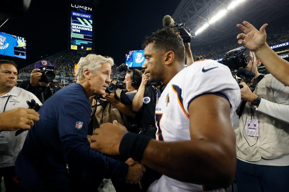 SEATTLE, WASHINGTON - SEPTEMBER 12: Head coach Pete Carroll of the Seattle Seahawks and Russell Wilson #3 of the Denver Broncos shake hands after their game at Lumen Field on September 12, 2022 in Seattle, Washington. (Photo by Steph Chambers/Getty Images)
