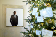 Former President Barack Obama's portrait is on display alongside decorations in the Grand Foyer of the White House during a press preview of holiday decorations at the White House, Monday, Nov. 28, 2022, in Washington. (AP Photo/Patrick Semansky)