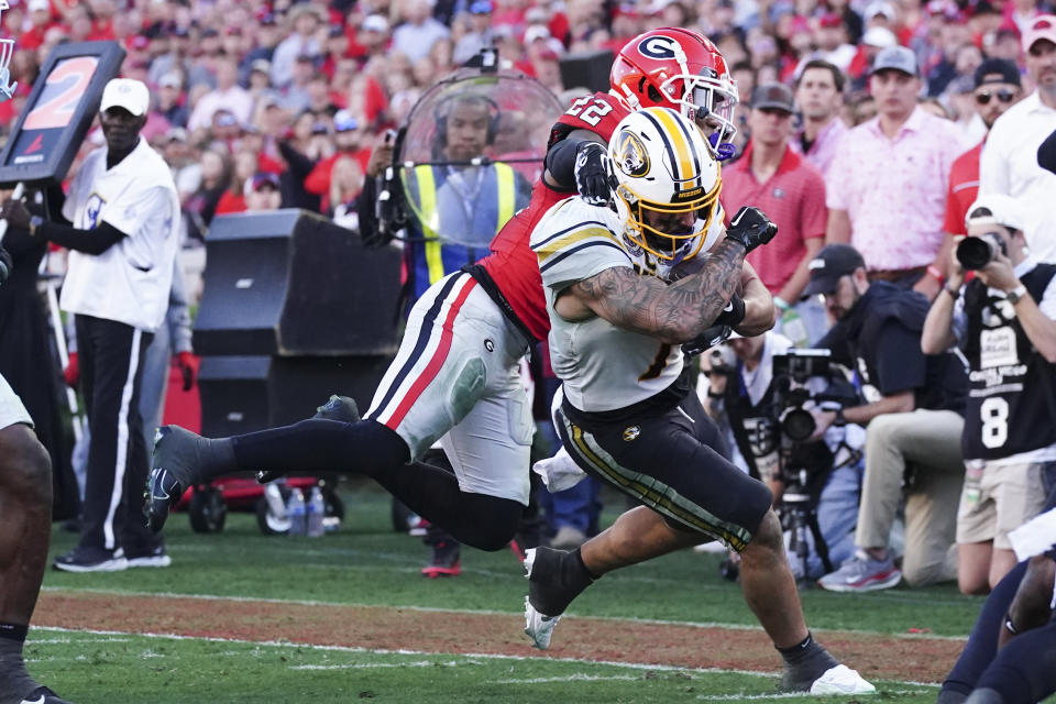 Missouri running back Cody Schrader (7) gets passed Georgia defensive back Javon Bullard (22) as he runs for a touchdown during the second half of an NCAA college football game, Saturday, Nov. 4, 2023, in Athens, Ga. (AP Photo/John Bazemore)