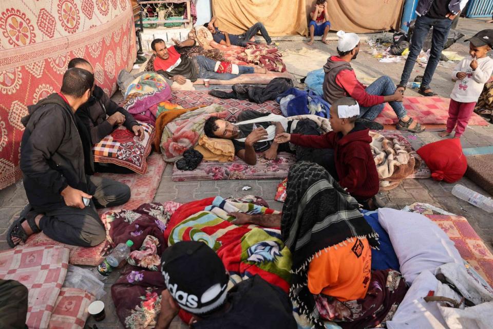 PHOTO: People injured in nearby Israeli air strikes rest at a school housing displaced Palestinians in Rafah, on the southern Gaza Strip, Oct. 24, 2023. (Mohammed Abed/AFP via Getty Images)