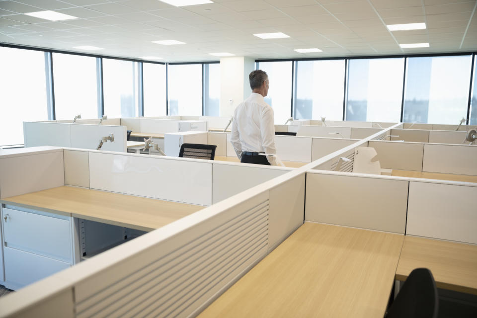 Businessman standing among cubicles in new office