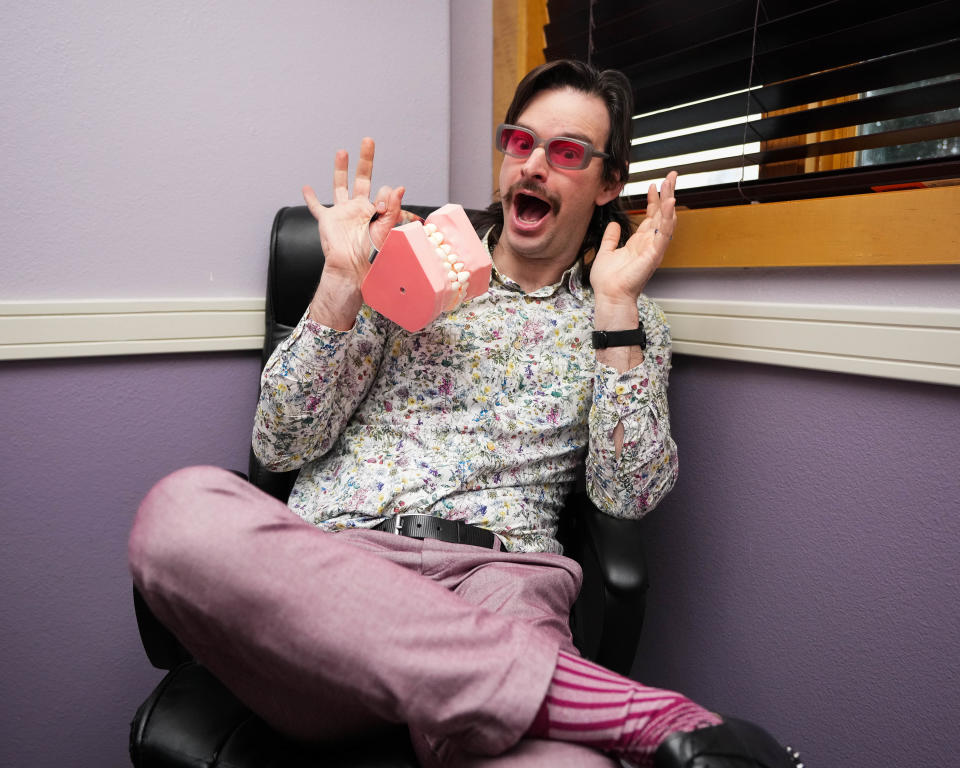 Brad Podray, known as Scumbag Dad on social media, poses for a photo in his orthodontics office in Ankeny.