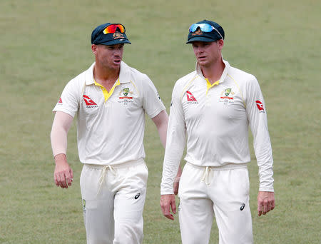 FILE PHOTO: Cricket - South Africa vs Australia - First Test Match - Kingsmead Stadium, Durban, South Africa - March 5, 2018. Australia's David Warner and Steve Smith leave the pitch after beating South Africa. REUTERS/Rogan Ward