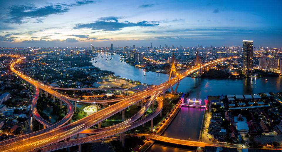 Aerial view of Bhumibol suspension bridge cross over Chao Phraya River in Bangkok city with car on the bridge at sunset sky and clouds in Bangkok Thailand. Source: Getty Images