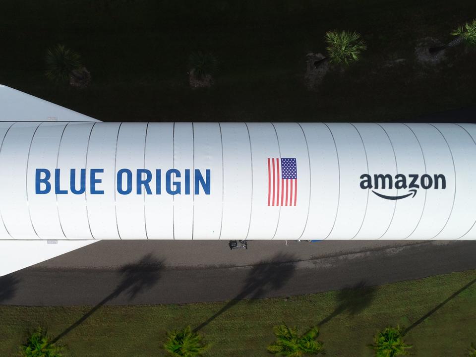 Overhead of the New Glenn rocket from Blue Origin, one of the three heavy-lift launch providers Amazon selected for Project Kuiper (featuring a mock-up of the Amazon logo)