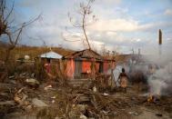 <p>Residents burn the debris of trees shattered by Hurricane Matthew, near Port-a-Piment, Haiti, Monday, Oct. 10, 2016. (AP Photo/Rebecca Blackwell)</p>