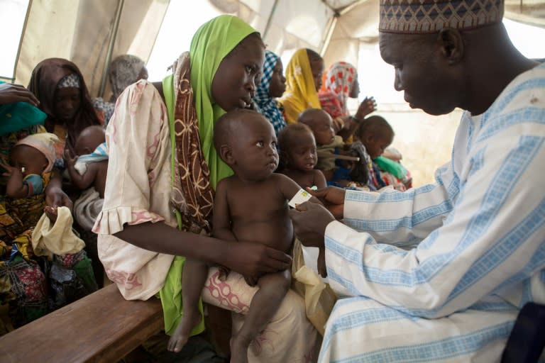 An health official measures the arm circumference of a child to control malnutrition at UNICEF Clinic near a camp for Internal displaced people (IDP) Camps in Dikwa, Nigeria February 14, 2017