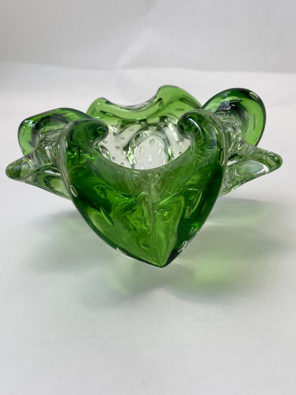 This distinctive green colored ashtray ($35) was likely created with proprietary additives to the melted glass.