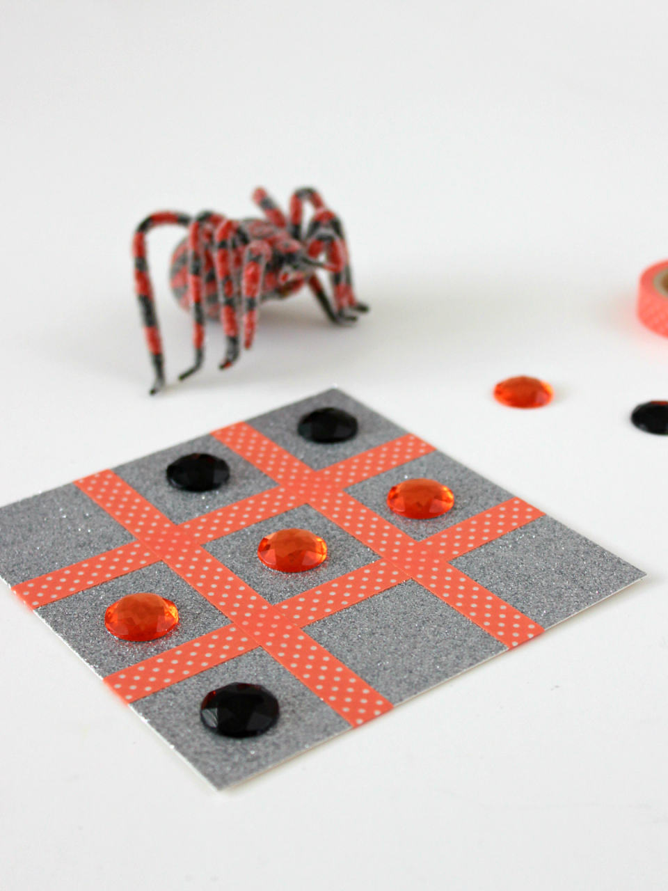 <p>The little ones can help make this game using festive washi tape and glitter paper — then use it for a fun round of good old tic tac toe!</p><p><em><a href="https://www.whitehousecrafts.net/post/2018/10/22/halloween-tic-tac-toe-with-washi-tape" rel="nofollow noopener" target="_blank" data-ylk="slk:Get the tutorial at White House Crafts »;elm:context_link;itc:0;sec:content-canvas" class="link ">Get the tutorial at White House Crafts »</a></em><br></p>