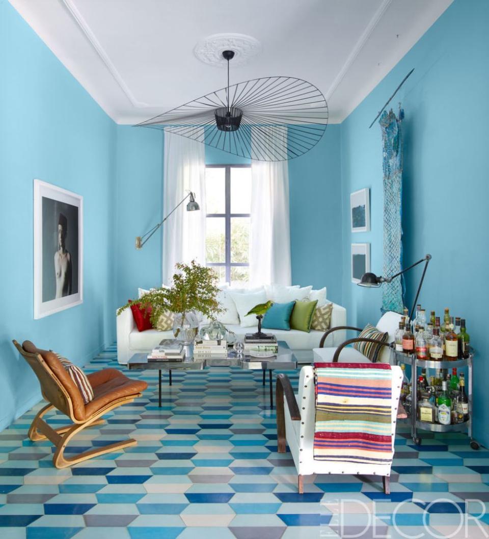 <p>Custom robin's-egg blue walls add a playful vibe to the living room of <a href="https://www.elledecor.com/design-decorate/house-interiors/news/g2618/house-tour-morocco-popham-design/?" rel="nofollow noopener" target="_blank" data-ylk="slk:Caitlin and Samuel Dowe-Sandes' Marrakech home;elm:context_link;itc:0;sec:content-canvas" class="link ">Caitlin and Samuel Dowe-Sandes' Marrakech home</a>. The floor is lined with handmade cement tiles by the couple's firm, Popham Design. <br></p>
