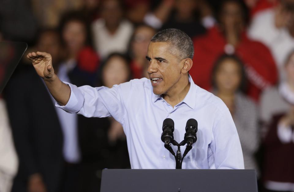 President Barack Obama addresses supporters at Wayne State University in Detroit, Saturday, Nov. 1, 2014. Obama's attendance is in support of democrats, gubernatorial candidate Mark Schauer and U.S. Senate candidate Gary Peters. (AP Photo/Carlos Osorio)