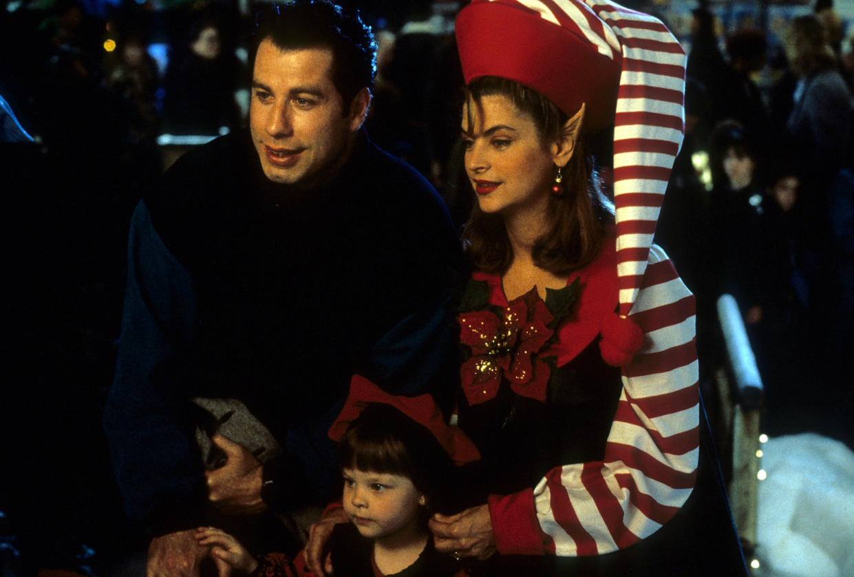 John Travolta, Kirstie Alley and two kids with the Christmas spirit in a scene from the film 'Look Who's Talking', 1989. (Photo by TriStar Pictures/Getty Images)