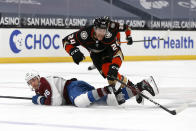 Anaheim Ducks forward Carter Rowney (24) falls over Colorado Avalanche forward Mikko Rantanen (96) during the first period of an NHL hockey game in Anaheim, Calif., Friday, Jan. 22, 2021. (AP Photo/Ringo H.W. Chiu)