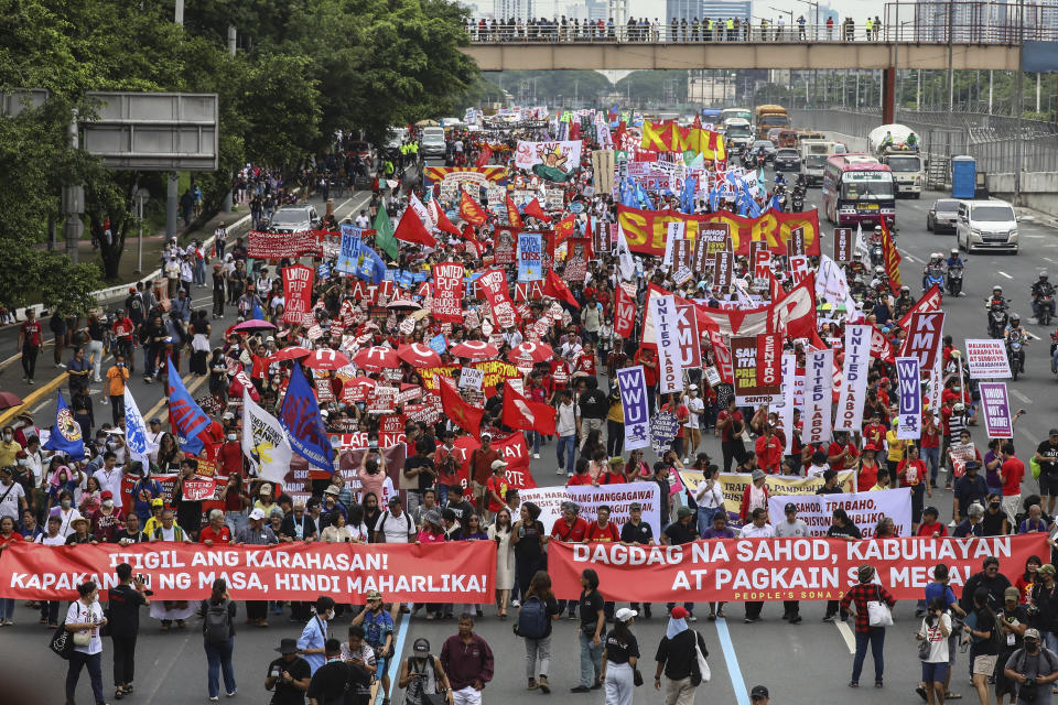 Protesters march along the main road heading to the House of Representatives in Quezon City, Philippines, Monday, July 24, 2023, ahead of the second State of the Nation Address of Philippine President Ferdinand Marcos Jr. (AP Photo/Gerard Carreon)