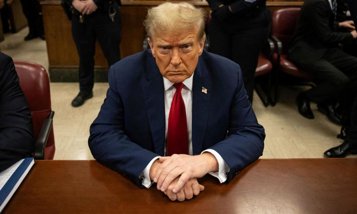 <span>Donald Trump at his trial for allegedly covering up hush-money payments linked to extramarital affairs, on 23 April 2024.</span><span>Photograph: Yuki Iwamura/AFP/Getty Images</span>