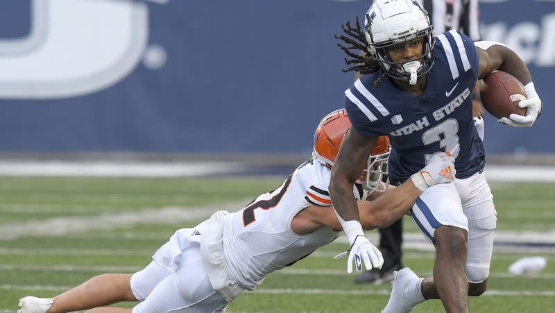 Utah State running back Rahsul Faison (3) carries the ball as Idaho State safety Mason Young (22) defends during the first half of an NCAA college football game Saturday, Sept. 9, 2023, in Logan, Utah. 